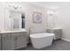 Bright bathroom features dual vanities, soaking tub, and modern fixtures; great for relaxation at 409 Retreat Ln, Canton, GA 30114