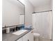 Modern bathroom featuring a sleek vanity, contemporary lighting, and a shower with curtain at 409 Retreat Ln, Canton, GA 30114