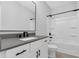 Modern bathroom featuring white vanity with gray countertop, tub with shower and chrome fixtures at 409 Retreat Ln, Canton, GA 30114
