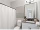 Modern bathroom featuring a sleek vanity, contemporary lighting, and a shower with curtain at 409 Retreat Ln, Canton, GA 30114