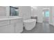 Modern bathroom with standalone tub, walk in shower, double vanities, and gray tile flooring at 409 Retreat Ln, Canton, GA 30114