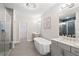 Stylish bathroom featuring dual vanities, free-standing tub, large mirror, and glass-enclosed shower at 409 Retreat Ln, Canton, GA 30114