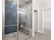 Shower with glass enclosure, built in seat, rainfall shower head and blue herringbone tiling at 409 Retreat Ln, Canton, GA 30114