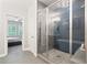 Modern bathroom showcases a glass-enclosed shower with herringbone tile, built in seat, and view to main bedroom at 409 Retreat Ln, Canton, GA 30114