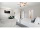 Open bedroom space with flat screen tv, green sitting chair, large windows, and carpet at 409 Retreat Ln, Canton, GA 30114