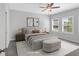 Cozy bedroom featuring neutral tones, plush bedding, and natural light streaming through the windows at 409 Retreat Ln, Canton, GA 30114