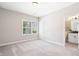 A spacious bedroom with plush carpet and a well-lit bathroom at 409 Retreat Ln, Canton, GA 30114