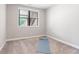 Bedroom features neutral walls, carpet and a sunlit window at 409 Retreat Ln, Canton, GA 30114