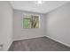 Clean, carpeted bedroom with lots of natural light looking onto the backyard stairs and landscaping at 409 Retreat Ln, Canton, GA 30114
