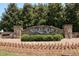 Stone community sign for River Green with landscaping and flowers at the entrance at 409 Retreat Ln, Canton, GA 30114