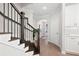 Bright entryway features hardwood floors, staircase with dark wood and iron railing, and white trim throughout at 409 Retreat Ln, Canton, GA 30114