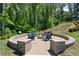 A cozy outdoor firepit area with chairs, perfect for entertaining in a serene, natural setting at 409 Retreat Ln, Canton, GA 30114