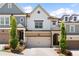 Charming exterior of a two-story home with brick accents, a two-car garage and manicured landscaping at 409 Retreat Ln, Canton, GA 30114