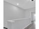 Upstairs hallway with gray walls, trim and wood-look vinyl plank flooring near the staircase at 409 Retreat Ln, Canton, GA 30114