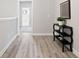 Hallway with wood floors, console table and access to bathroom at 409 Retreat Ln, Canton, GA 30114