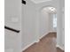 Hallway showcasing pristine hardwood floors, neutral wall colors, and arched doorway providing a clean aesthetic at 409 Retreat Ln, Canton, GA 30114