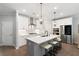 Modern kitchen with white cabinets, stainless steel appliances, a large island, and pendant lighting at 409 Retreat Ln, Canton, GA 30114