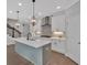 Beautiful kitchen featuring a large island, white cabinets, stainless steel appliances, and modern pendant lighting at 409 Retreat Ln, Canton, GA 30114