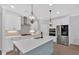 Modern kitchen with a spacious island, stainless steel appliances, and stylish pendant lighting, perfect for cooking at 409 Retreat Ln, Canton, GA 30114