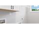 A well-lit laundry room featuring bright white cabinets and sleek black hardware at 409 Retreat Ln, Canton, GA 30114