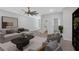 Open concept living room featuring neutral color palette, ceiling fan, and seamless flow to other areas at 409 Retreat Ln, Canton, GA 30114