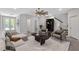 Bright and airy living room with light gray walls, neutral furniture, ceiling fan, and access to patio at 409 Retreat Ln, Canton, GA 30114