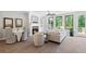 Inviting living space with a fireplace, comfortable sofa, large windows, and a view of the outdoor greenery at 409 Retreat Ln, Canton, GA 30114
