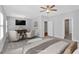 Spacious primary bedroom with ceiling fan, sitting area, and en-suite bathroom at 409 Retreat Ln, Canton, GA 30114