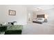 Expansive main bedroom boasts plush carpet, sitting area, tufted headboard, and ensuite bathroom at 409 Retreat Ln, Canton, GA 30114