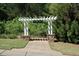Entrance to the Heritage Trail, featuring a pergola over a paved walkway surrounded by lush greenery at 409 Retreat Ln, Canton, GA 30114