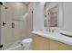Modern bathroom featuring a glass enclosed shower with a rain shower head and a vanity with gold hardware at 4881 Bill Cheek Rd, Auburn, GA 30011