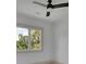Cozy bedroom with ceiling fan and a large window showcasing the tree-lined landscape at 4881 Bill Cheek Rd, Auburn, GA 30011