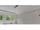 Bedroom features large windows, a tray ceiling with modern light fixture, and custom wall trim at 4881 Bill Cheek Rd, Auburn, GA 30011