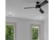 Bedroom featuring a ceiling fan and windows with views of mature trees at 4881 Bill Cheek Rd, Auburn, GA 30011