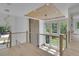 Bright foyer showcasing a modern railing, wood ceiling detail, and ample light from large windows at 4881 Bill Cheek Rd, Auburn, GA 30011