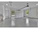 Spacious three car garage featuring large windows, recessed lighting, and epoxy flooring at 4881 Bill Cheek Rd, Auburn, GA 30011