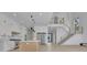 Open-concept kitchen featuring an island, stainless steel appliances, and modern pendant lighting at 4881 Bill Cheek Rd, Auburn, GA 30011