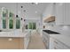 Spacious kitchen with white cabinets, stainless steel appliances, and hardwood floors at 4881 Bill Cheek Rd, Auburn, GA 30011