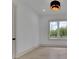 Sun-filled room with modern lighting and views of the backyard at 4881 Bill Cheek Rd, Auburn, GA 30011