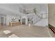 Open-concept living space with a modern kitchen, grand staircase, and fireplace at 4881 Bill Cheek Rd, Auburn, GA 30011
