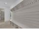 Bright mudroom featuring built in shelving and seating adjacent to hallway at 4881 Bill Cheek Rd, Auburn, GA 30011