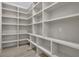 Large walk-in pantry with custom built shelving for ample storage at 4881 Bill Cheek Rd, Auburn, GA 30011
