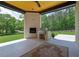 Outdoor patio with brick fireplace, grill, and patterned rug for entertaining at 4881 Bill Cheek Rd, Auburn, GA 30011