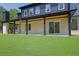 Covered patio with brick pillars, wood ceiling, and view of spacious backyard at 4881 Bill Cheek Rd, Auburn, GA 30011