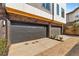 Two-car garage with modern doors, exterior lighting, and updated brick and siding at 1237 Memorial Se Dr # 302, Atlanta, GA 30316