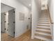 Hallway with wooden stairs, gray doors, and light wood flooring with white trim at 1237 Memorial Se Dr # 302, Atlanta, GA 30316