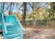 A light blue deck overlooks the cozy backyard with stone fire pit and privacy fence at 1316 Plaza Sw Ave, Atlanta, GA 30310