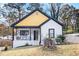 Charming renovated home with a yellow gable, front porch, and fresh landscaping at 1316 Plaza Sw Ave, Atlanta, GA 30310
