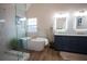 Elegant bathroom boasting walk-in shower, soaking tub, double sink vanity, and modern flooring at 1412 Shelnutt Ct, Hampton, GA 30228