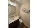 Modern half bath features a floating vanity, sleek mirror, and stylish fixtures at 1412 Shelnutt Ct, Hampton, GA 30228